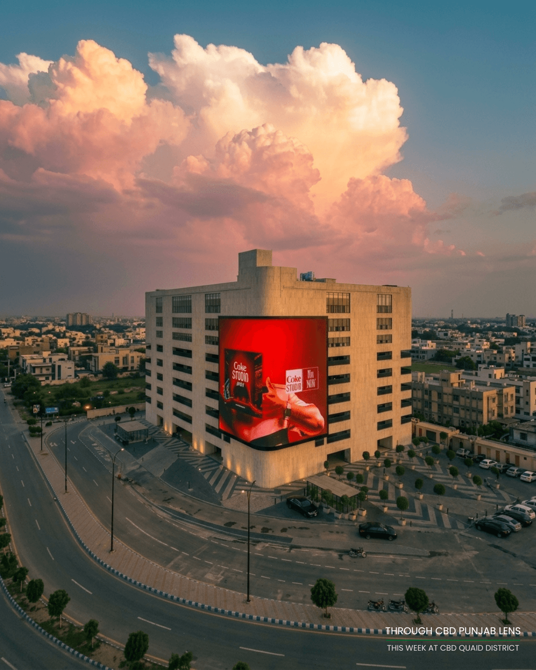 A Coca-Cola brand takeover filling BIG ONE's entire display beneath dramatic clouds