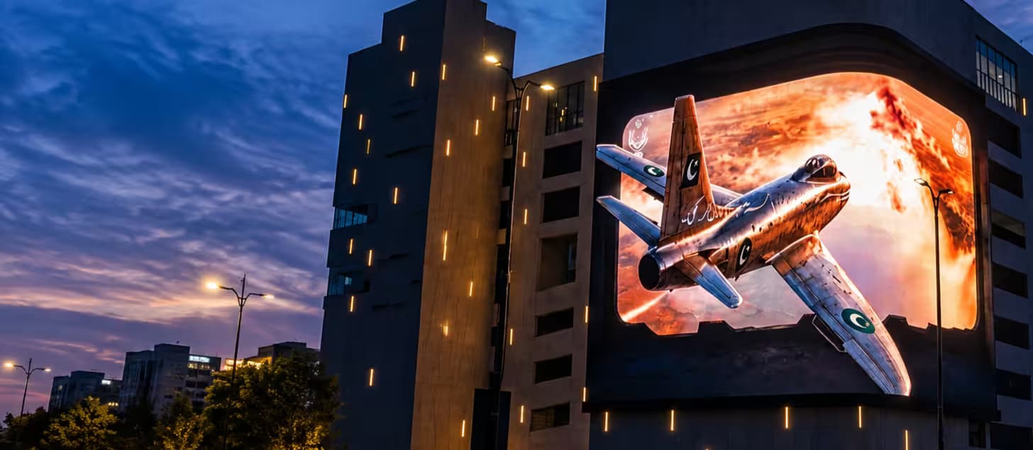 BIG ONE's curved LED display showing a 3D fighter jet creative above Lahore at dusk